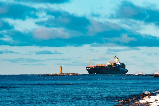 Modern black container ship moving from Baltic sea