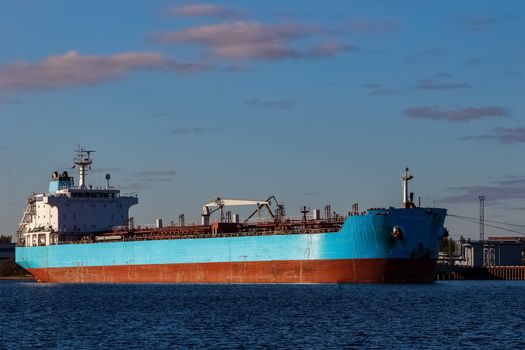 Blue cargo ship loading in the port of Riga, Europe