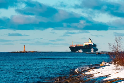 Modern black container ship moving from Baltic sea