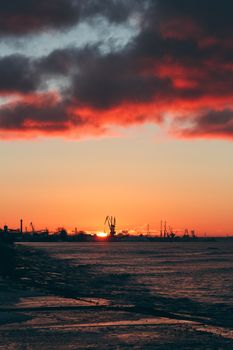 Hot winter sunrise over the cargo port in Riga