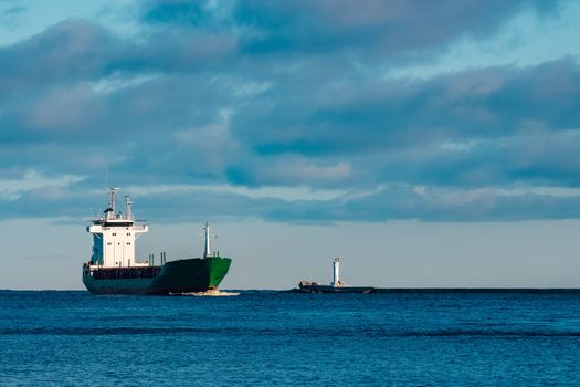 Green bulk carrier sailing from the Baltic sea