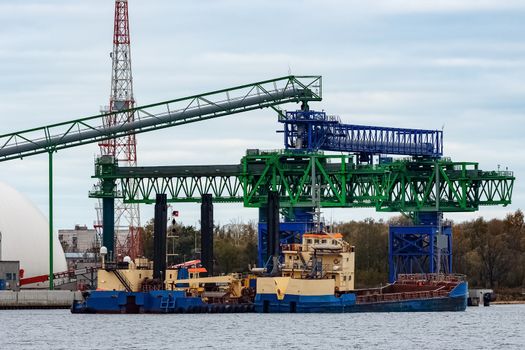 Blue cargo ship loading in the port of Riga, Europe