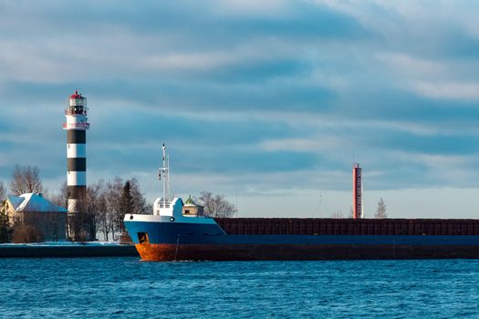 Blue bulk carrier sailing in still water