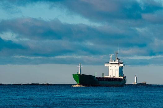 Green bulk carrier sailing from the Baltic sea