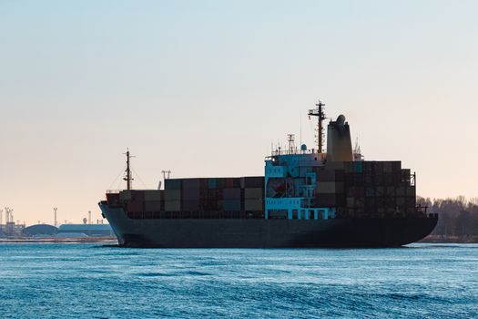 Modern black container ship moving from Baltic sea