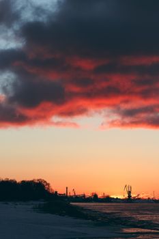 Hot winter sunrise over the cargo port in Riga