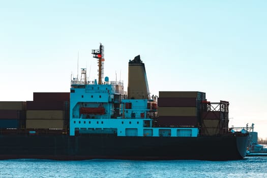 Modern black container ship moving from Baltic sea