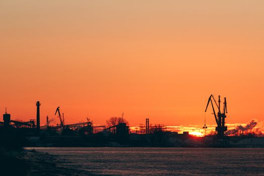 Hot winter sunrise over the cargo port in Riga