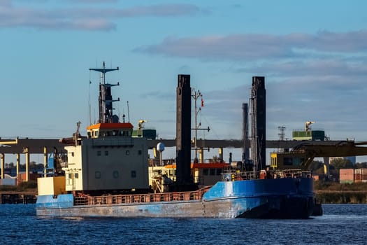 Blue cargo ship in the port of Riga, Europe