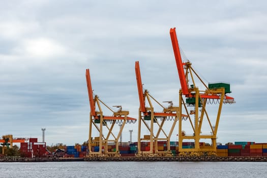 Yellow cargo cranes in the port of Riga, Europe
