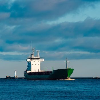 Green bulk carrier sailing from the Baltic sea