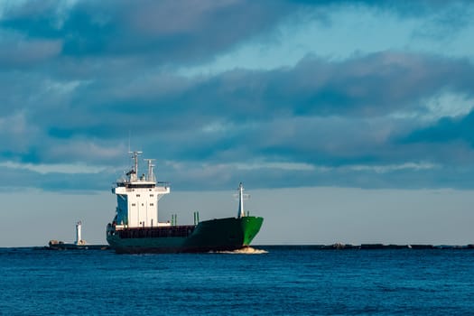 Green bulk carrier sailing from the Baltic sea