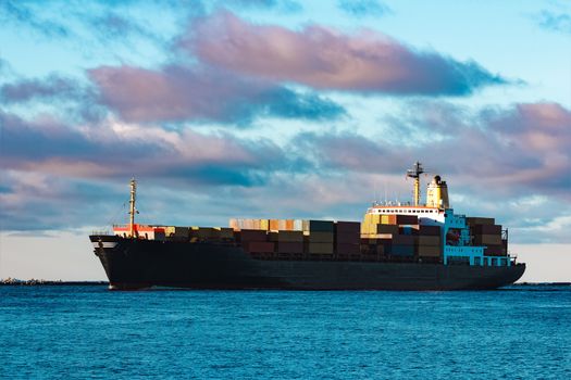 Modern black container ship moving from Baltic sea