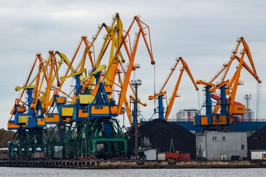 Yellow cargo cranes in the port of Riga, Europe