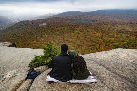 Two hikers watching fall foliage around Mount Washington in New Hampshire, USA
