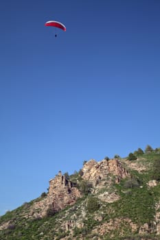 Parasailing in a blue sky in Chimgan mountains, Uzbekistan