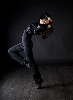 Modern style woman dancer over black background