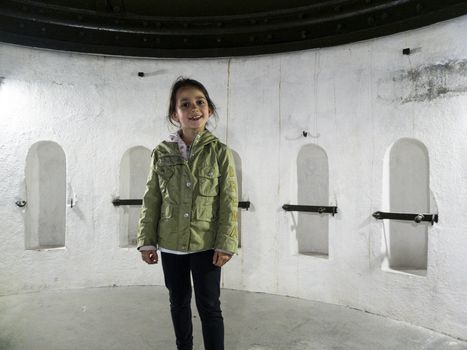 Italy, Bormio, Venini Fort, portrait of a girl inside a fort of the second world war while she is visiting it as a tourist