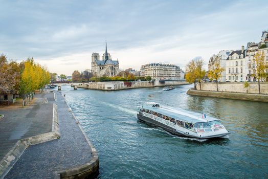 Peniche boat full of tourists in Paris in fall