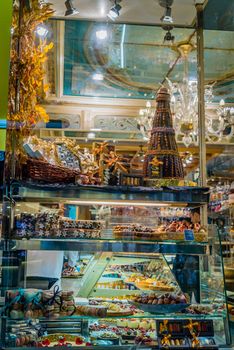 Sweets and chocolates in display window in Paris by night