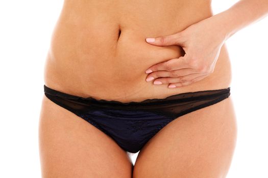 Closeup shot of overweight woman pinching her excessive belly fat, isolated on white background