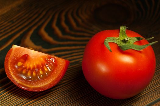 Ripe Red Tomatoes on a Wooden Table with Black Background. Dark Rustic Old Style