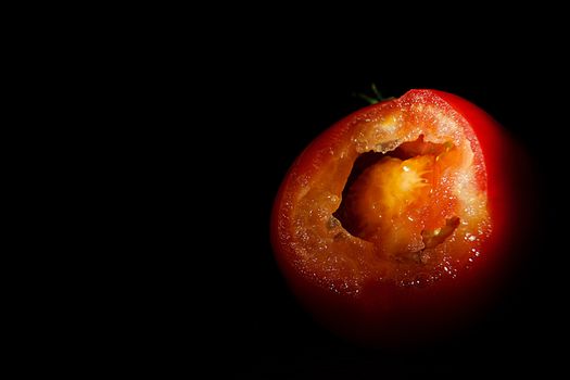 Ripe Red Tomatoes on a Wooden Table with Black Background. Dark Rustic Old Style