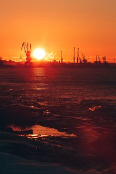 Hot winter sunrise over the cargo port in Riga