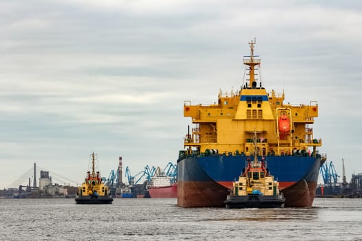 Blue cargo ship entering the port of Riga, Europe