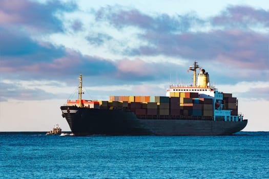 Modern black container ship moving from Baltic sea