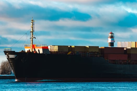 Modern black container ship moving from Baltic sea