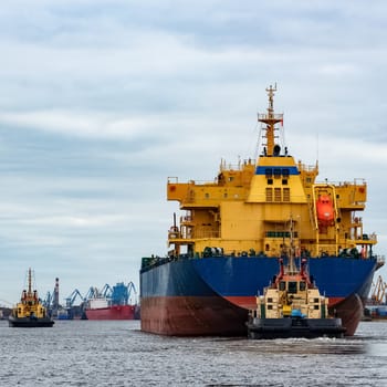 Blue cargo ship entering the port of Riga, Europe