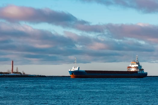 Blue bulk carrier sailing in still water