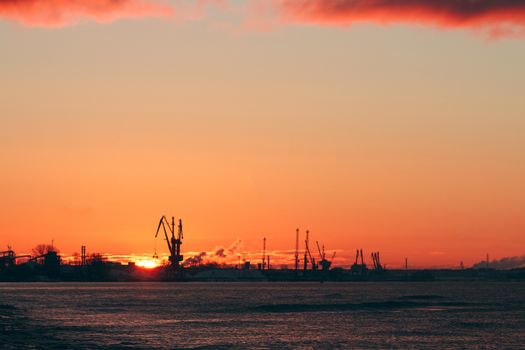 Hot winter sunrise over the cargo port in Riga
