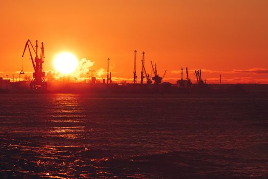 Hot winter sunrise over the cargo port in Riga
