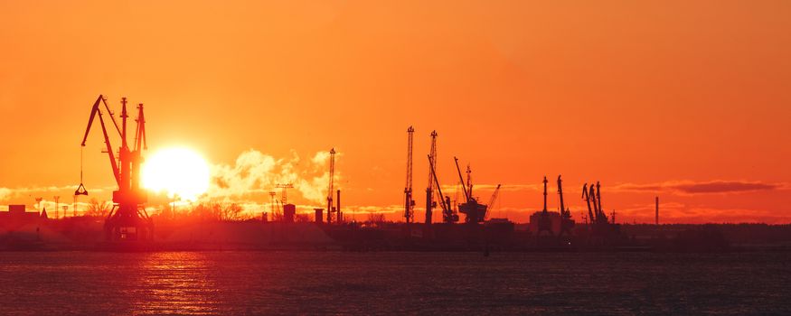 Hot winter sunrise over the cargo port in Riga