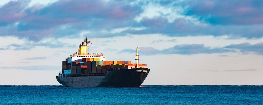 Modern black container ship moving from Baltic sea