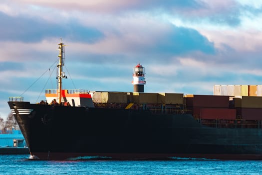 Modern black container ship moving from Baltic sea