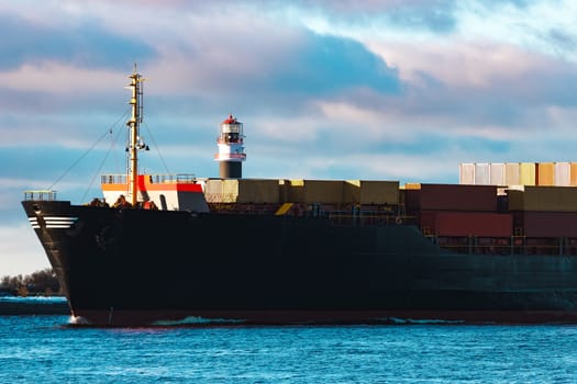 Modern black container ship moving from Baltic sea