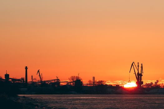 Hot winter sunrise over the cargo port in Riga
