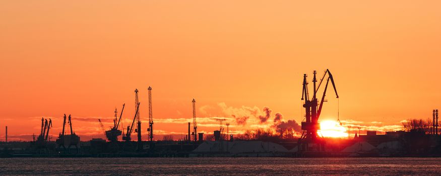Hot winter sunrise over the cargo port in Riga