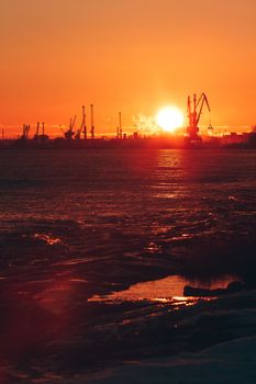 Hot winter sunrise over the cargo port in Riga