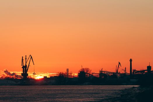 Hot winter sunrise over the cargo port in Riga
