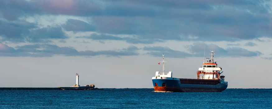 Blue bulk carrier sailing in still water