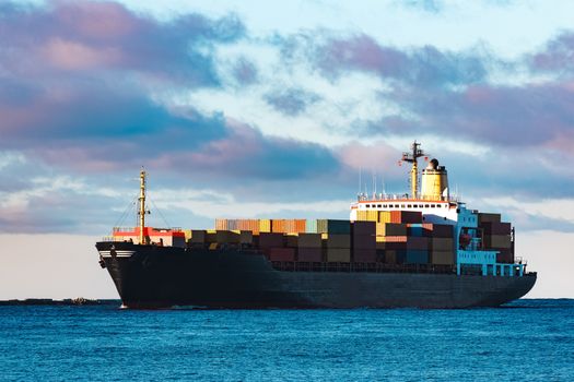 Modern black container ship moving from Baltic sea