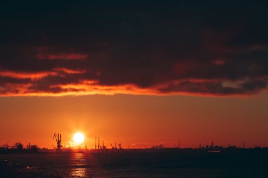 Hot winter sunrise over the cargo port in Riga