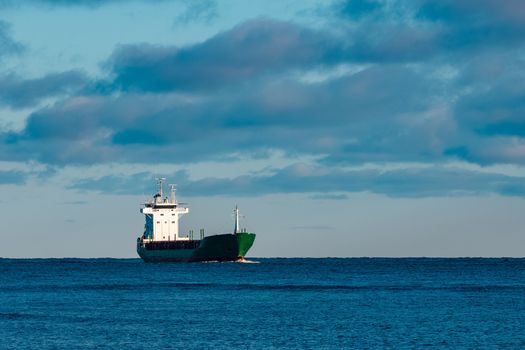 Green bulk carrier sailing from the Baltic sea