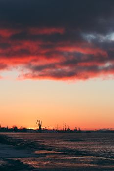 Hot winter sunrise over the cargo port in Riga