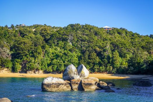 Round stone boulder and sand bay in Abel Tasman National Park. New Zealand