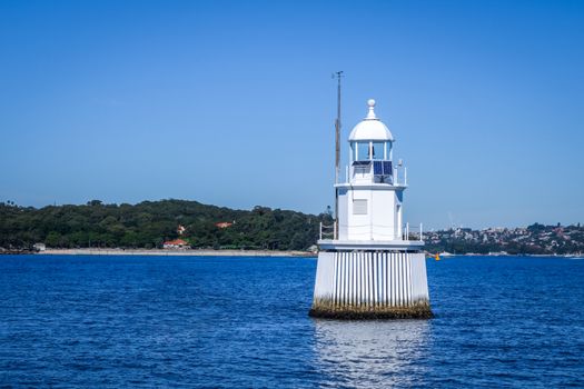 White lighthouse in the sea, Sydney bay, Australia